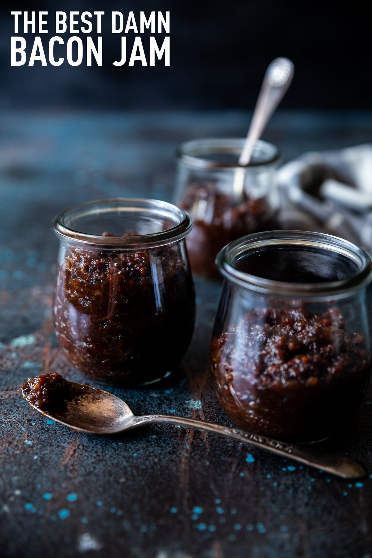 Bacon jam in small tulip jars, spoon with bacon jam on it