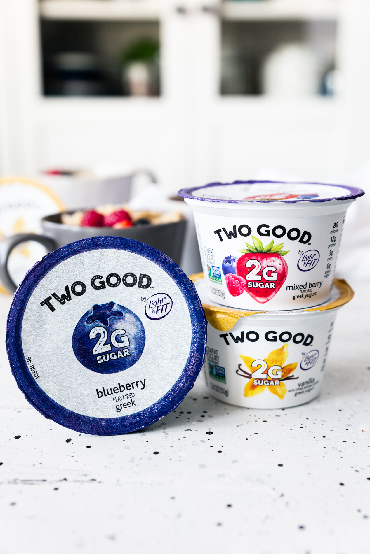 side view of three containers of Two Good yogurt