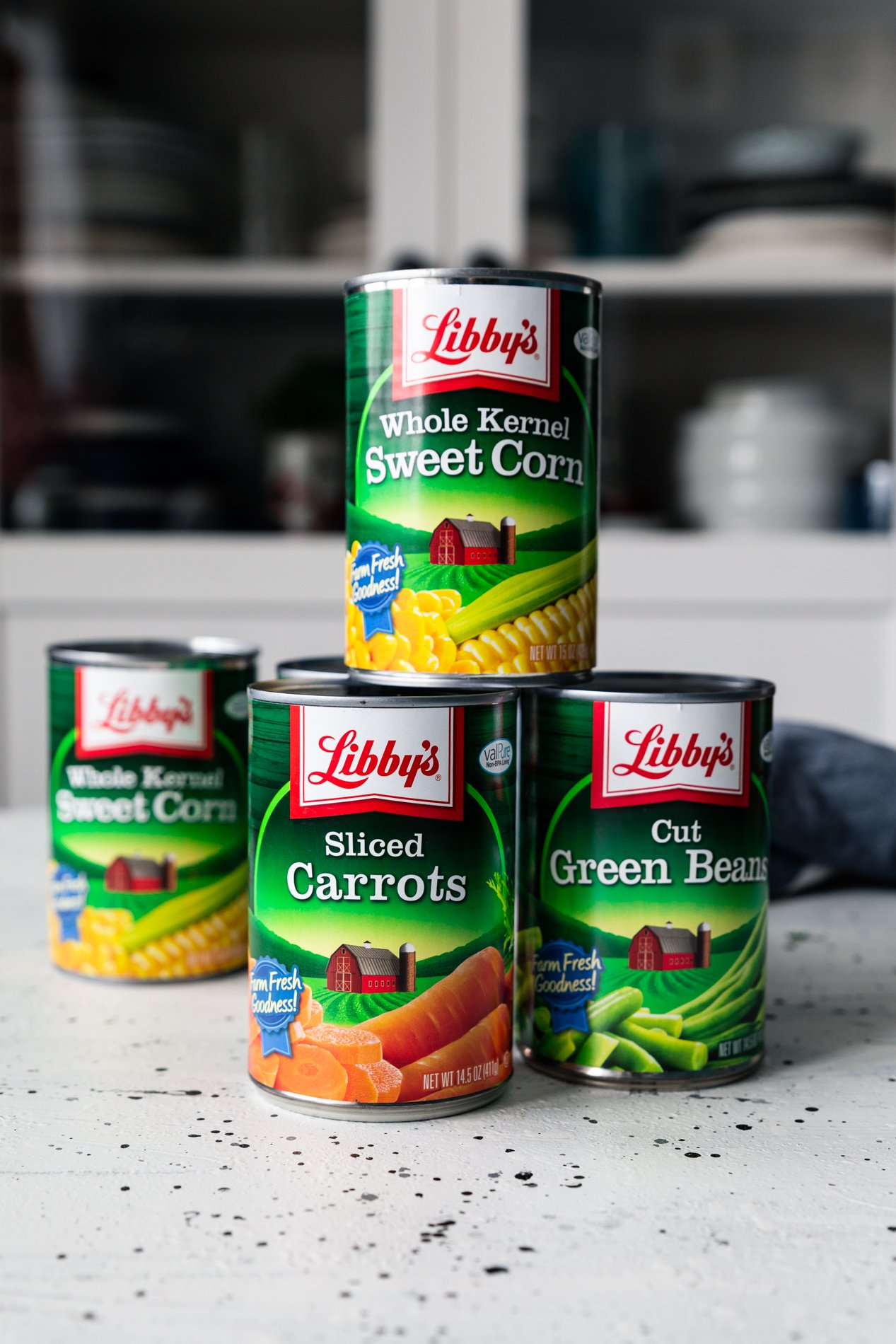 straight forward view of cans of Libby's corn, carrots, and green beans.