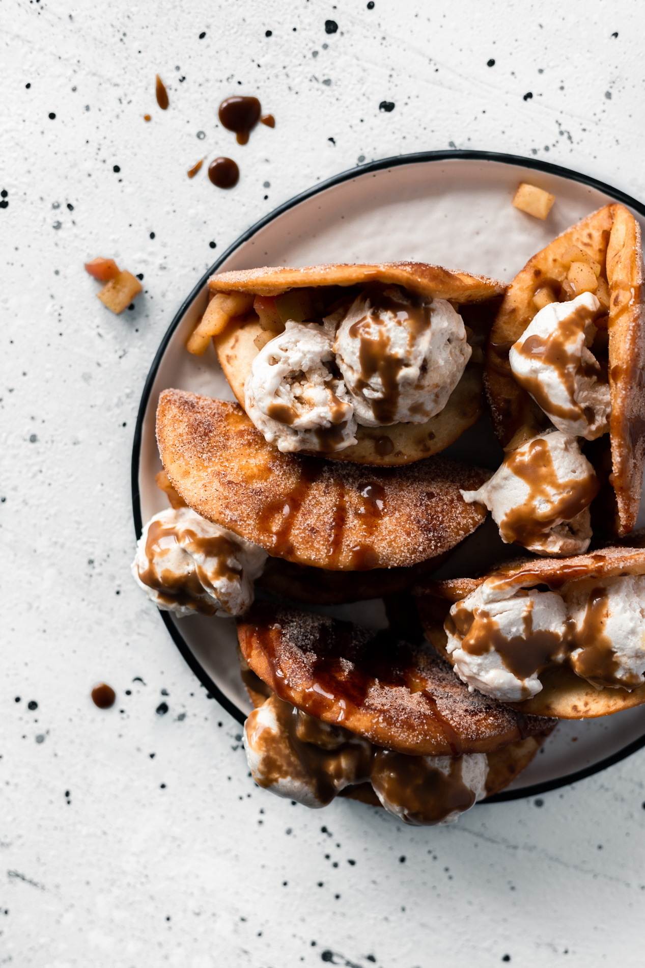 overhead view of a plate of easy apple crumble dessert tacos with coconut caramel drizzle