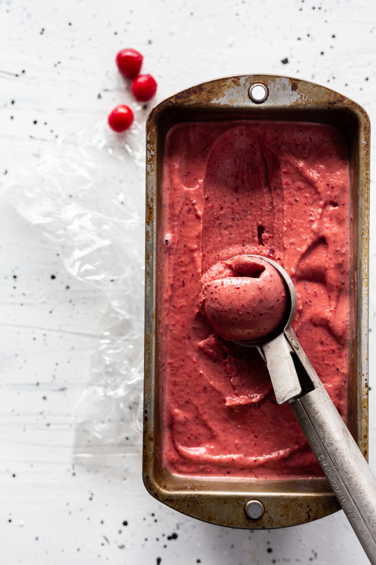 overhead view of instant cherry ice cream with a scoop taken out of it