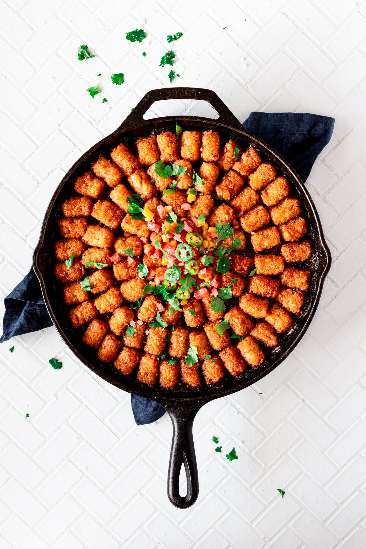 overhead view of a skillet with not yo mama's tater tot hotdish fresh from the oven