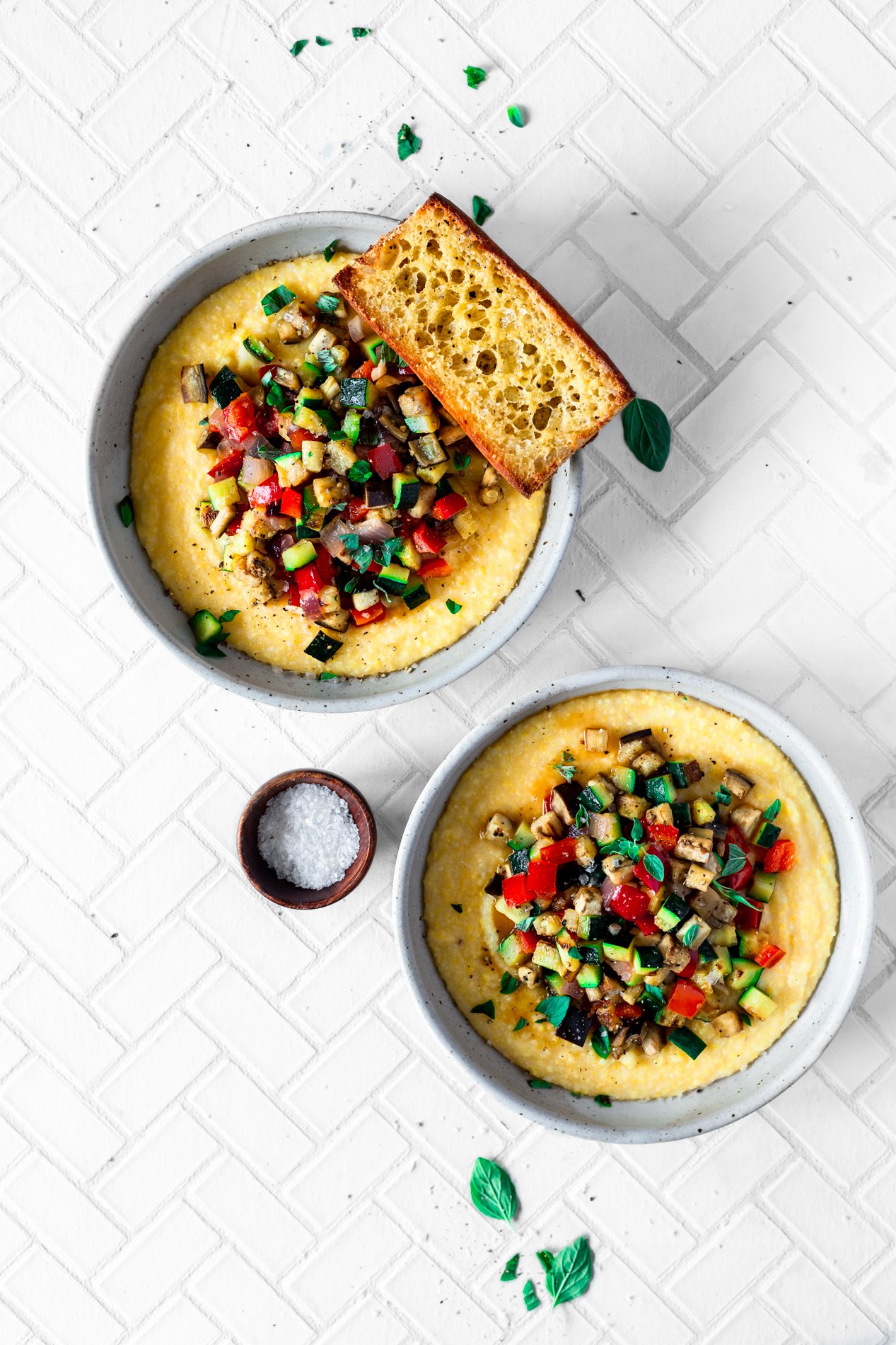 overhead view of two bowls of easy ratatouille recipe with creamy polenta