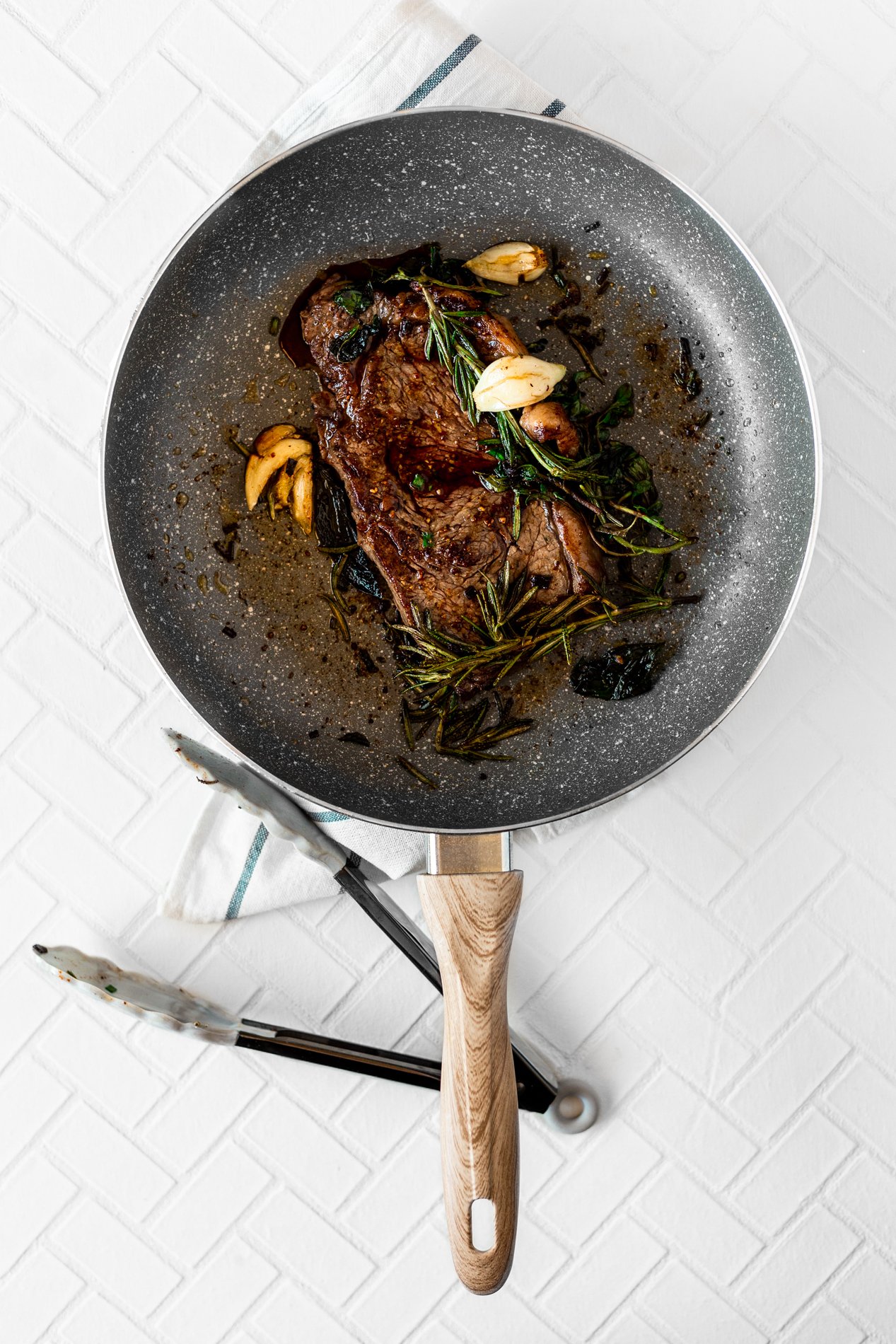 overhead view of skillet with chipotle herb pan seared steak recipe