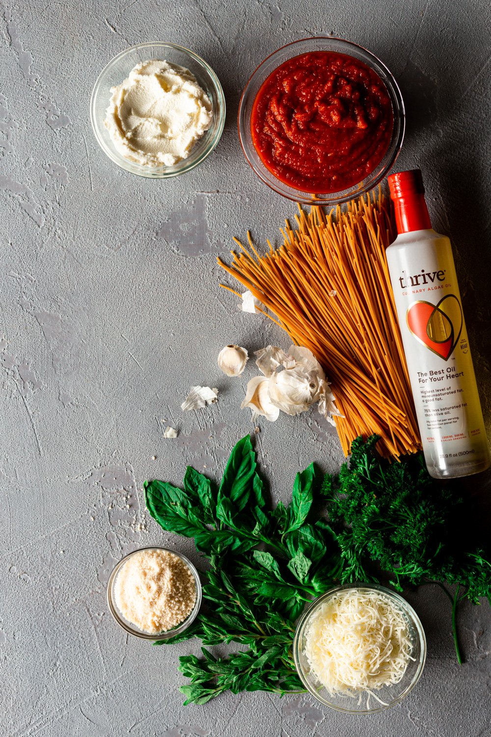 ingredients for gluten free spaghetti pie on a grey background