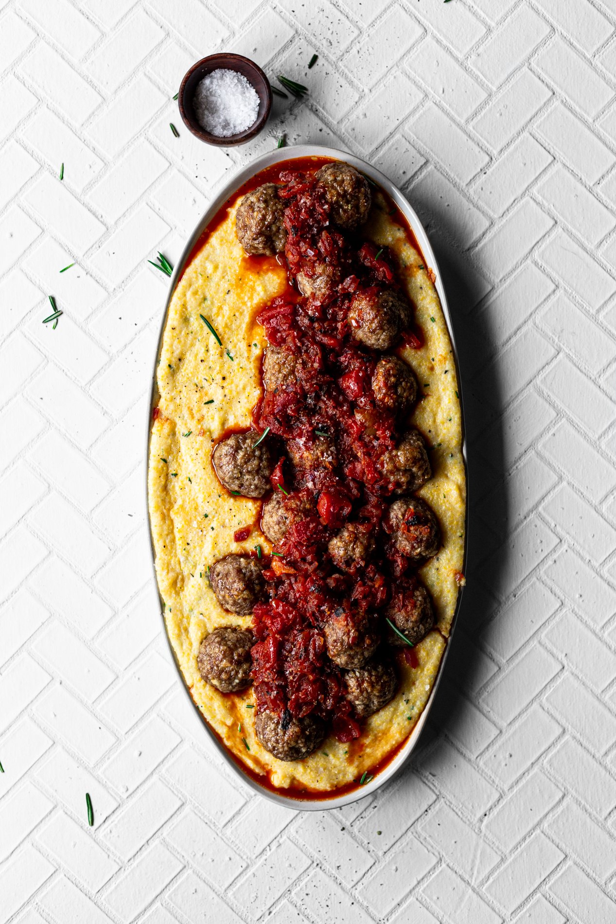 platter of rosemary polenta and lamb meatballs with fire-roasted red pepper sauce