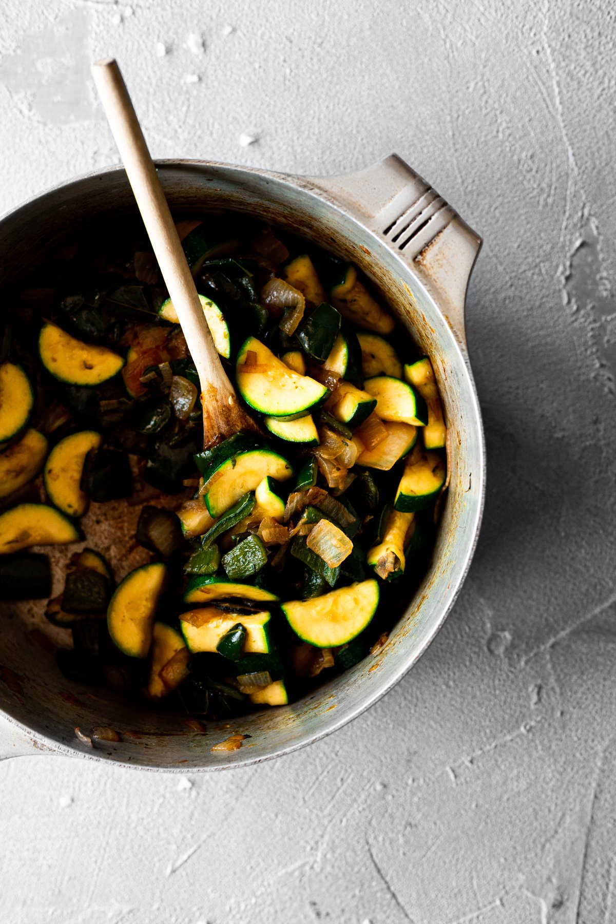 large pot with cooked onion, shallot, poblano peppers, and zucchini