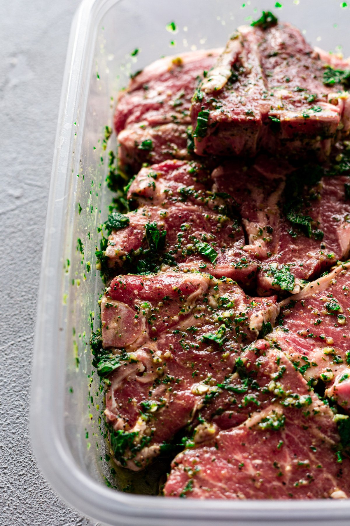 mint-schug marinated lamb chops in a tub before being grilled