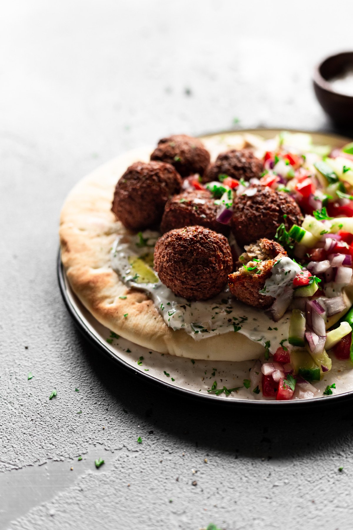 falafel on a pita with hummus, tzatziki, and israeli salad